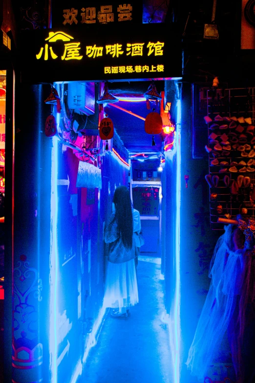 a woman walks down the street in a brightly lit tunnel