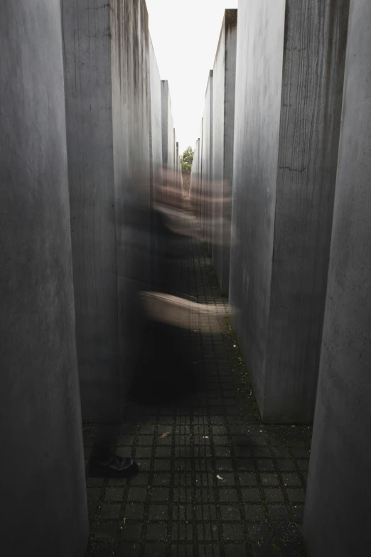 a long row of buildings with people walking through the walkway