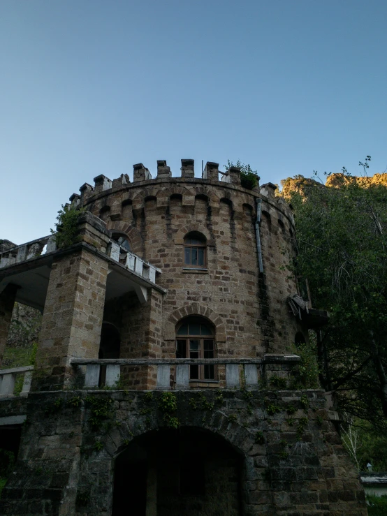 a castle like building on the edge of a forest