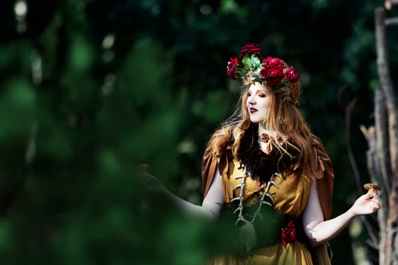 a girl dressed as a fairy holds a leaf