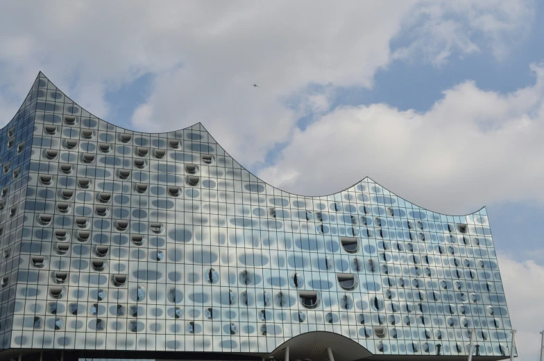 large building with a massive glass window and sky background