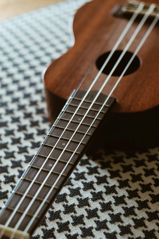 a ukelele on a checkered black and white cloth