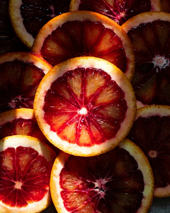 orange halves on display with water dripping from the top