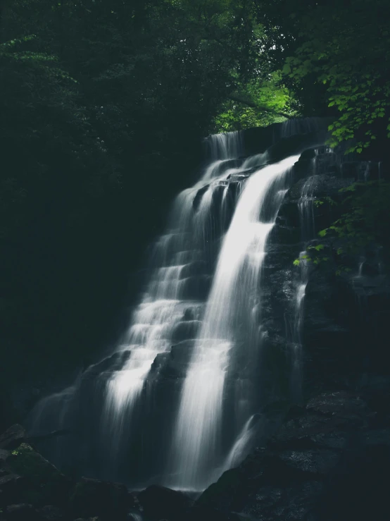 there is a waterfall that is surrounded by trees