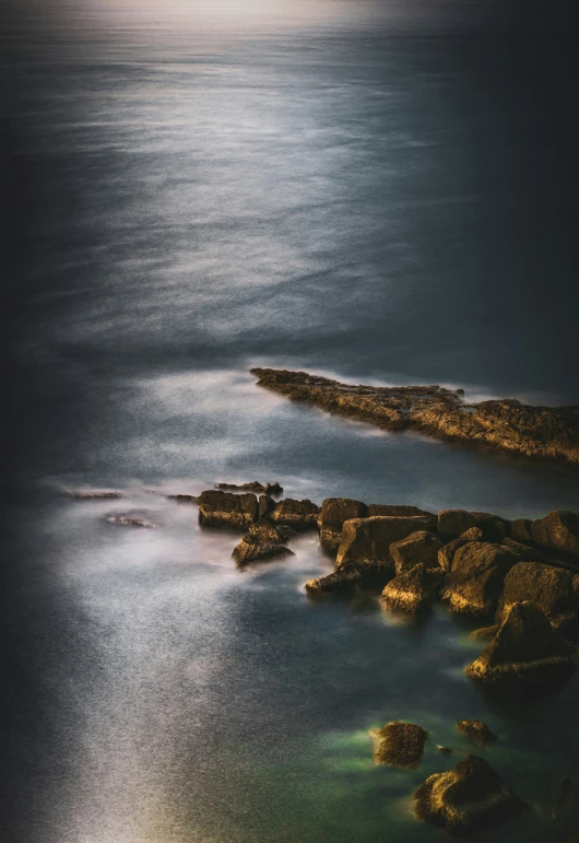 a full view of water with rocky shore in the foreground