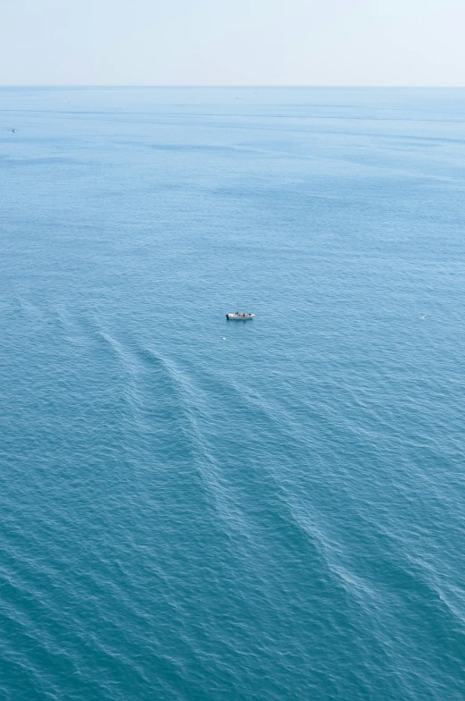an image of a small boat that is out in the middle of water