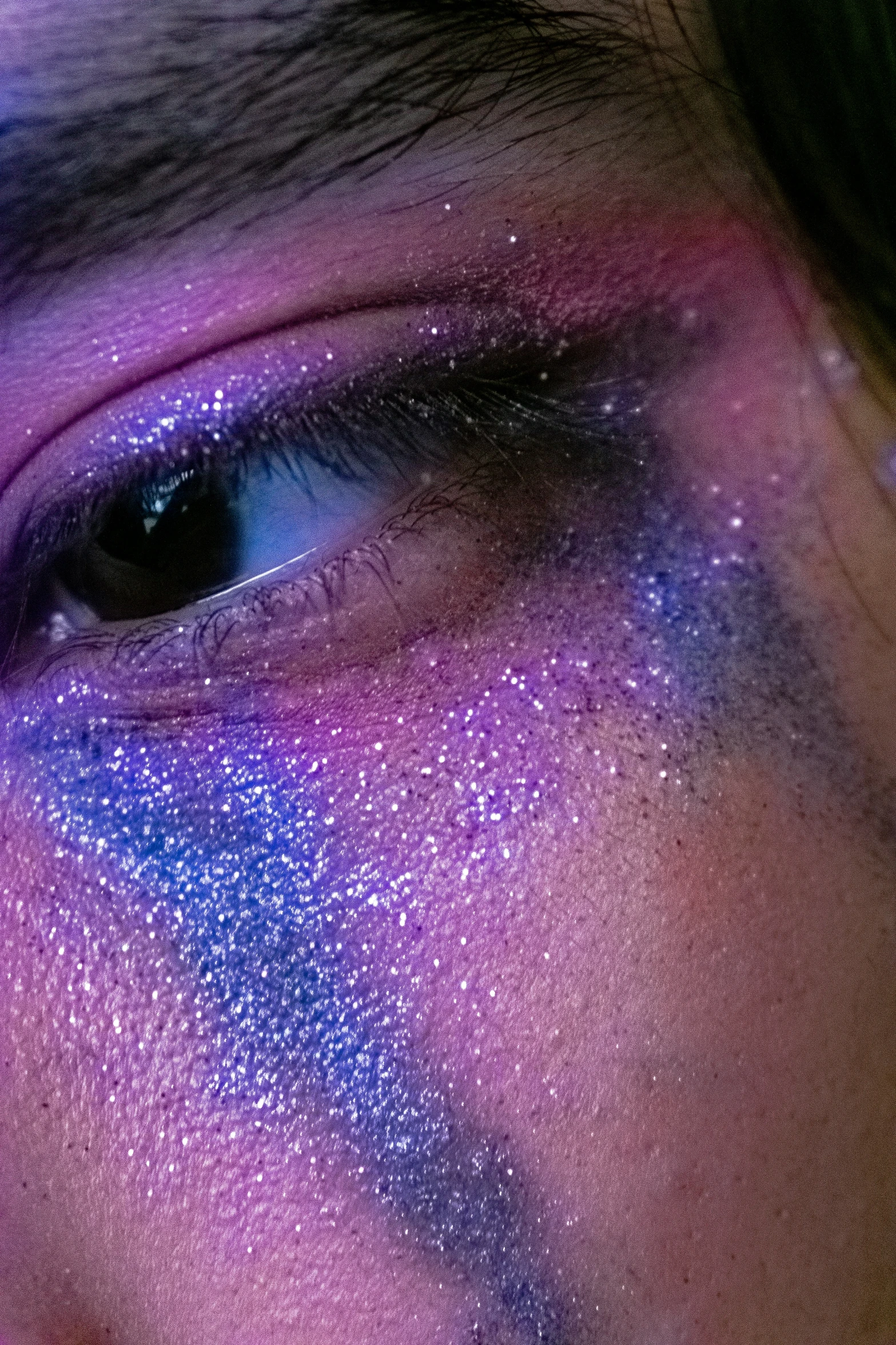 a person with purple makeup on their face