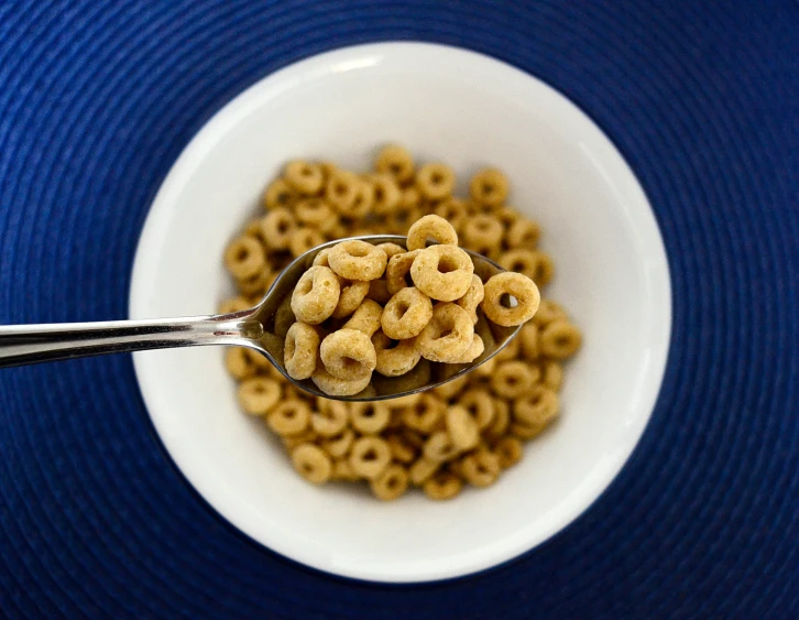 there are some cereal with a spoon in it