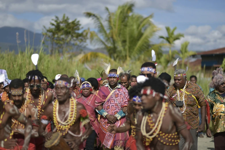 an african family dressed in colorful clothes standing together