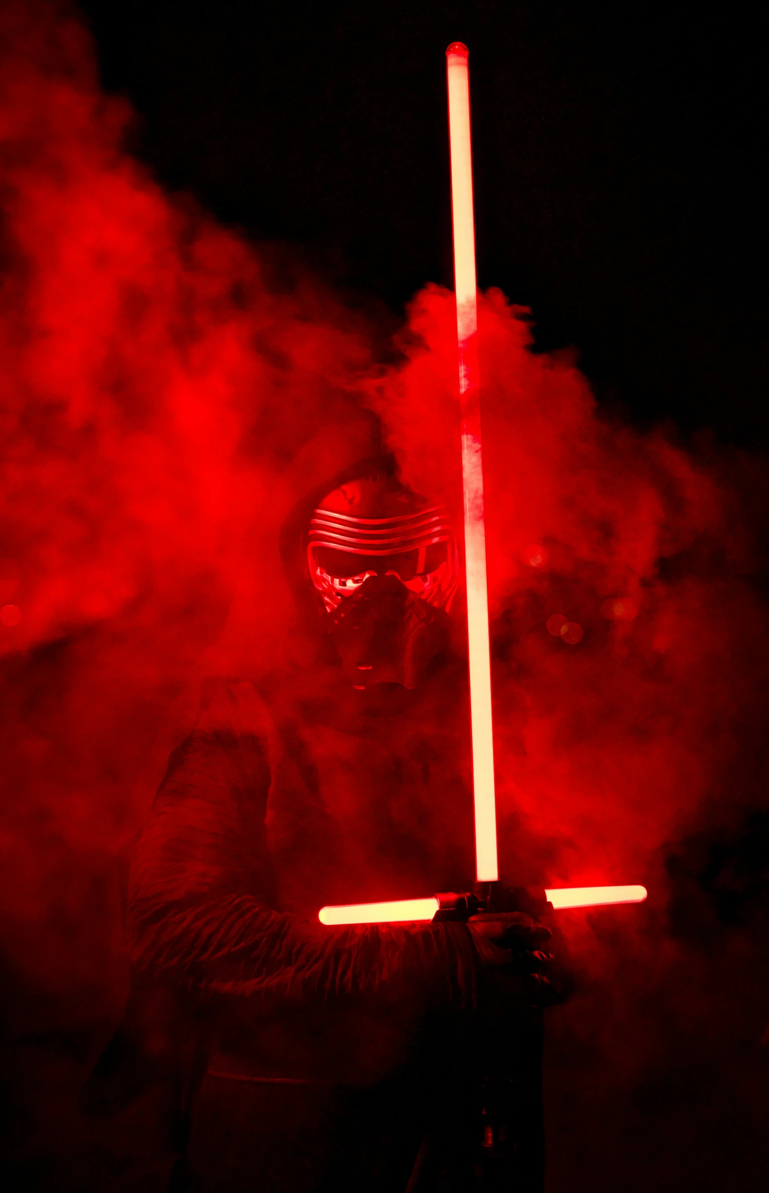 a man holding a saber in his right hand, with a red background