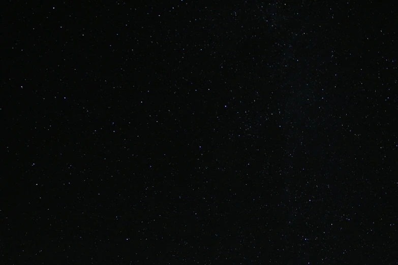 a very dark and starry sky with little clouds