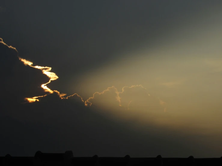 an airplane is flying in the sky with a sunbeam