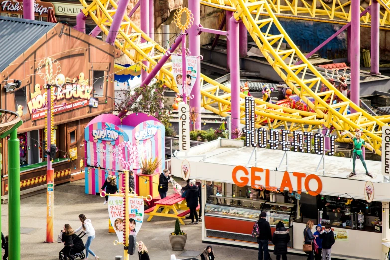 the fair goers and carnival rides are shown