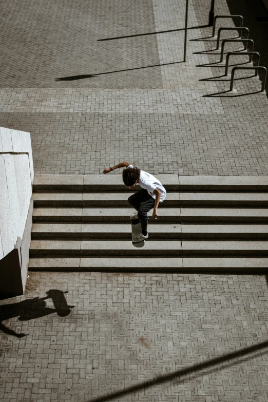 man flying over stairs and landing in front of steps