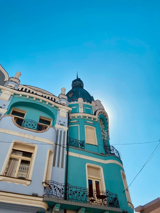 view looking up at a blue and white building