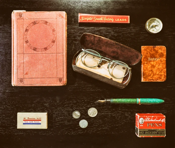 a black table with some items and a pen