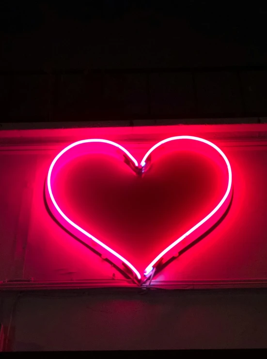 the back side of a neon heart sign