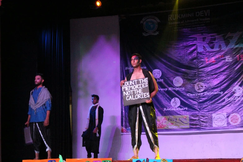 a man standing on the runway holding a sign saying, get off the remote and get away the clock