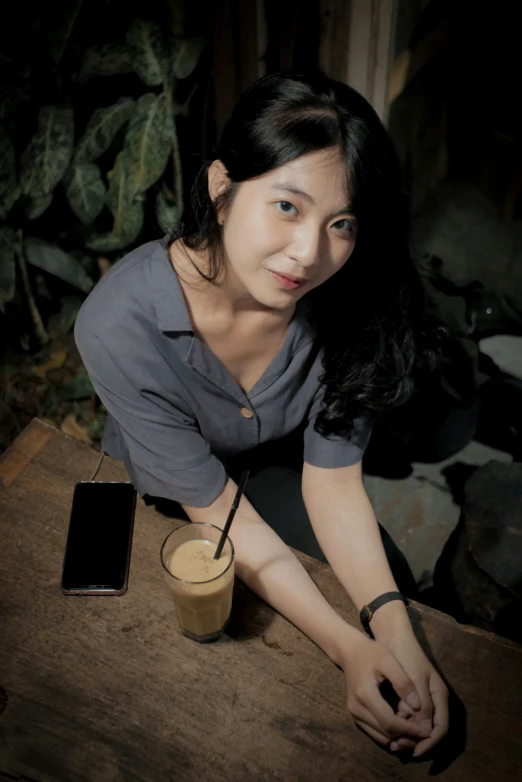 a woman with a glass is posing for the camera