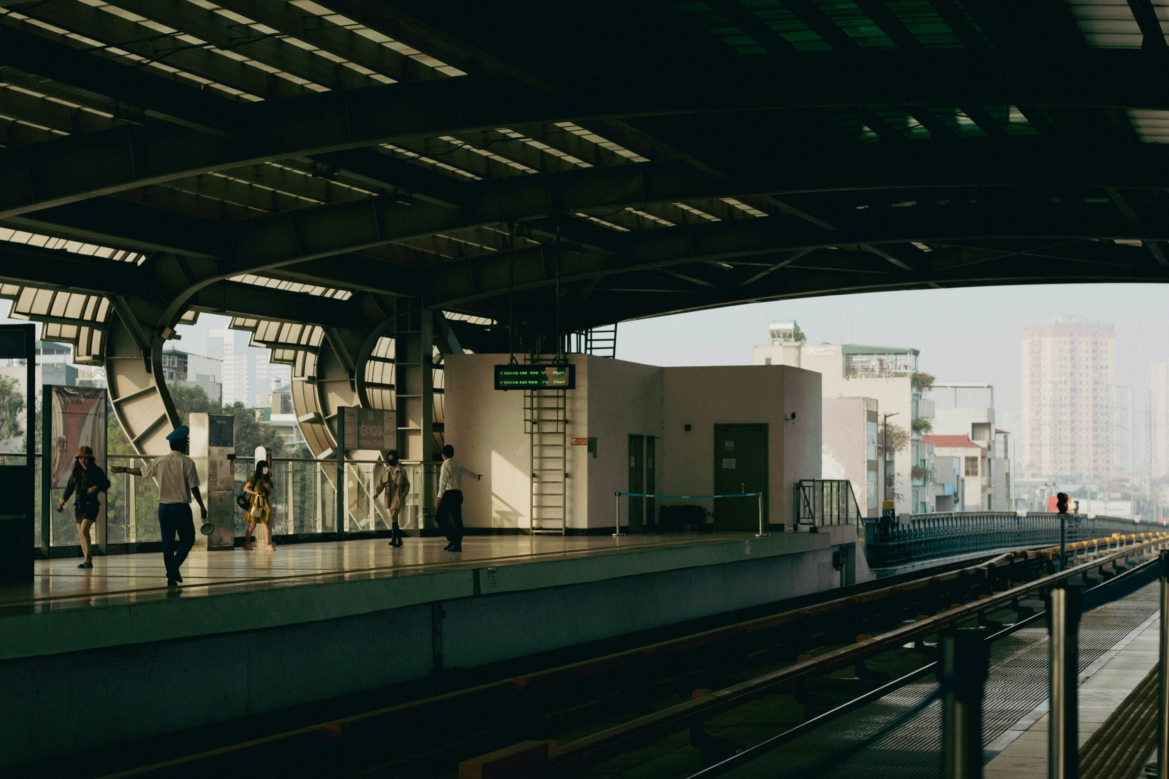 people walking in a city while one waits for the train