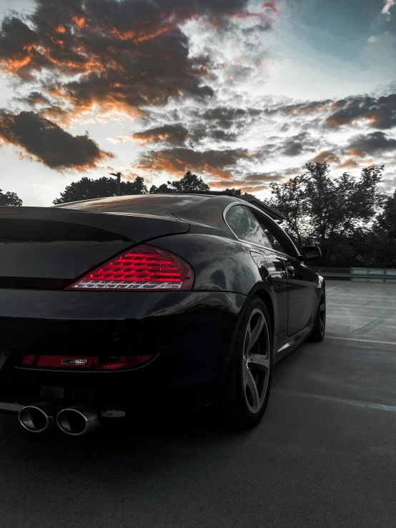 this is a black sporty car parked in a parking lot