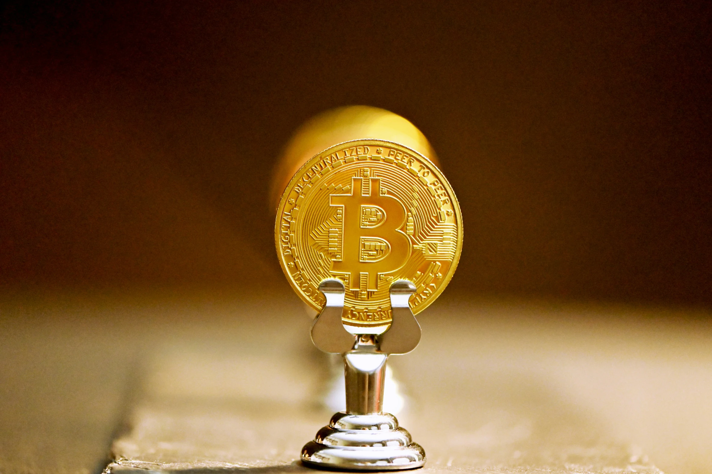 the gold bitcoin is on top of a gold coin