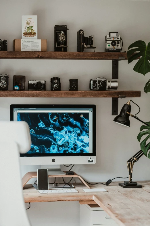a desktop with camera on it is sitting on a desk