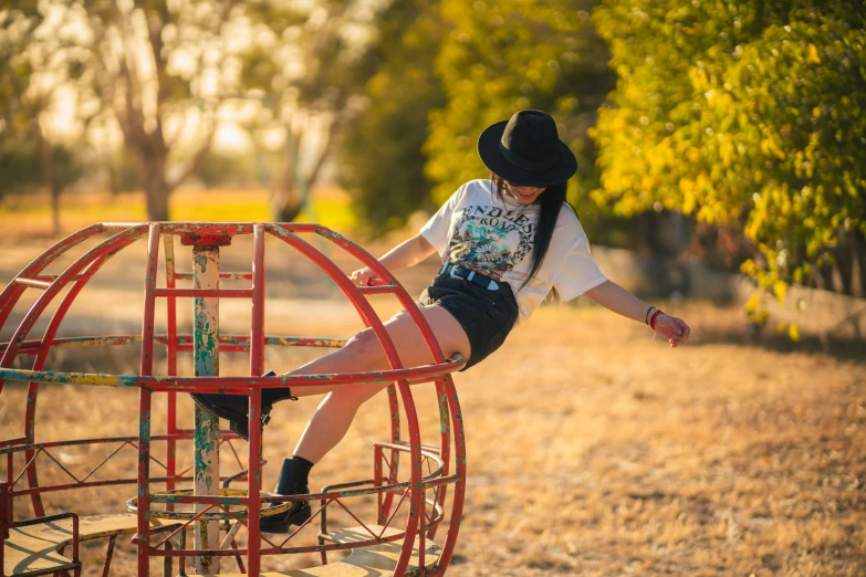 a person with a cowboy hat standing on a red structure