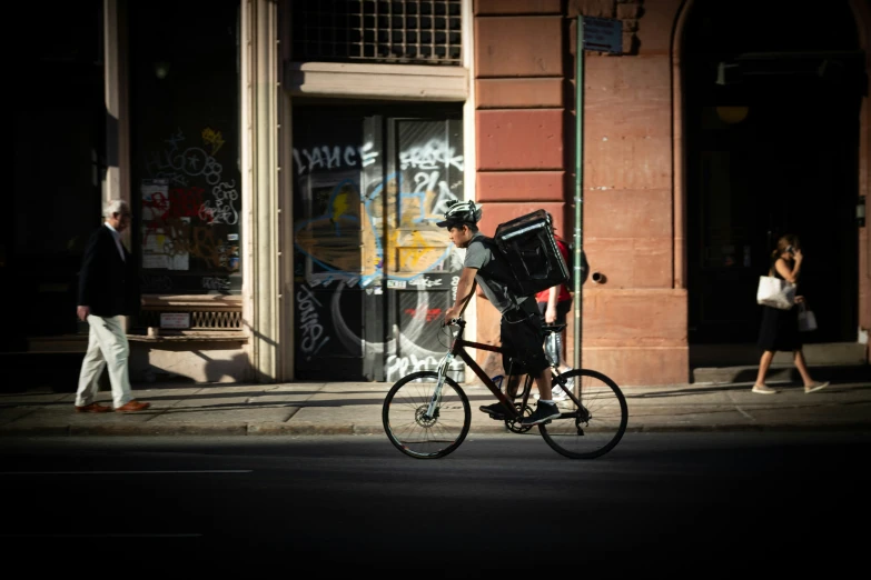 a man riding his bike down a street