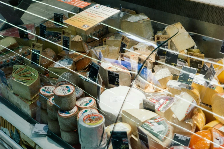 several slices of cheese in a case at a market