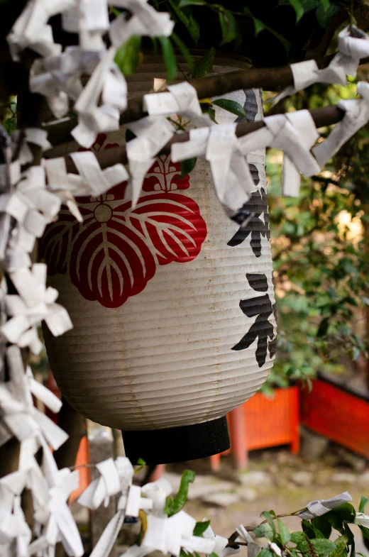 white hanging decorations with red and black designs