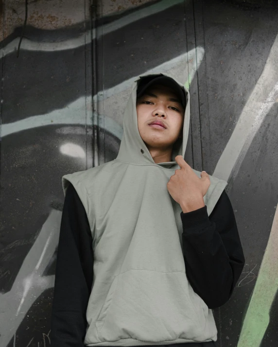 a young man in grey hoodie holding an umbrella