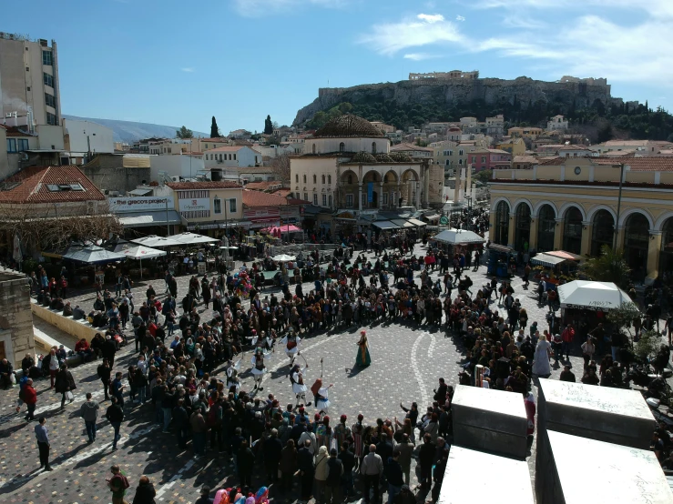 a crowded street with a castle in the background