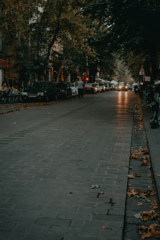 a row of parked cars on side of street