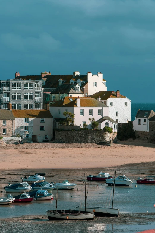 the houses are beside the boats and shore