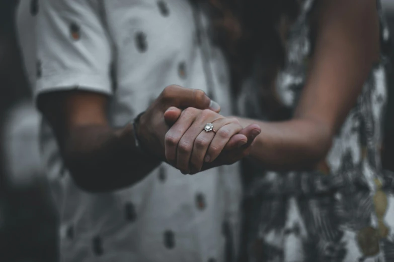 two people are holding hands while both hold hands