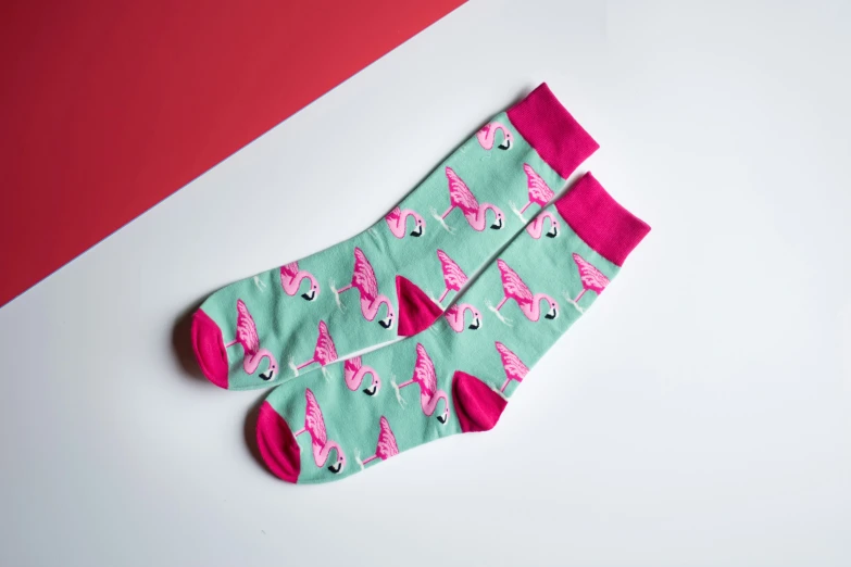 pink flamingos and green socks on white background