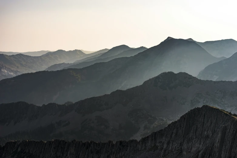 there is a lone plane flying over a mountain range