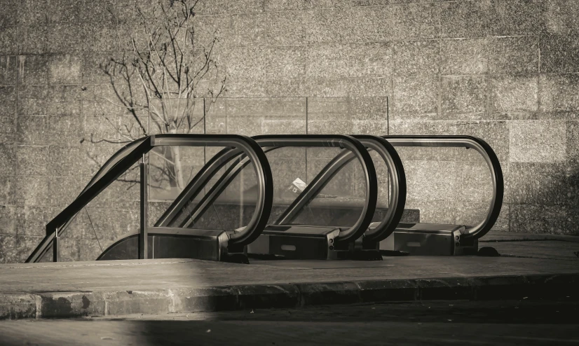 a row of escalators next to a wall