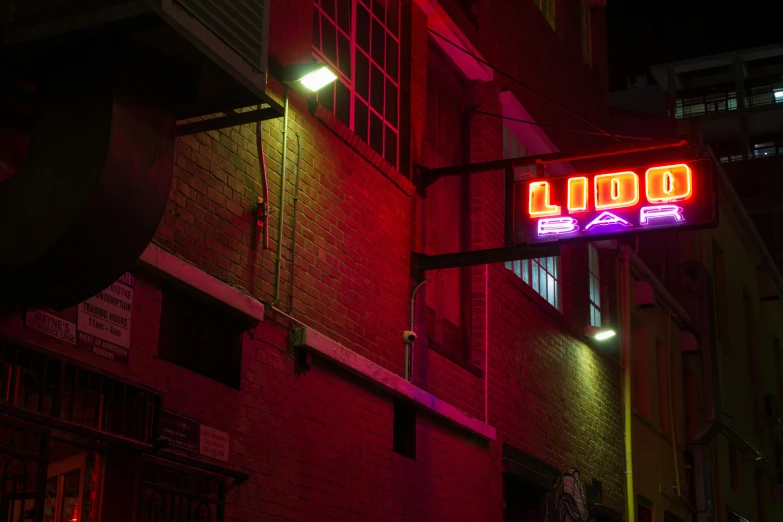 a neon sign reads good life above it in the night