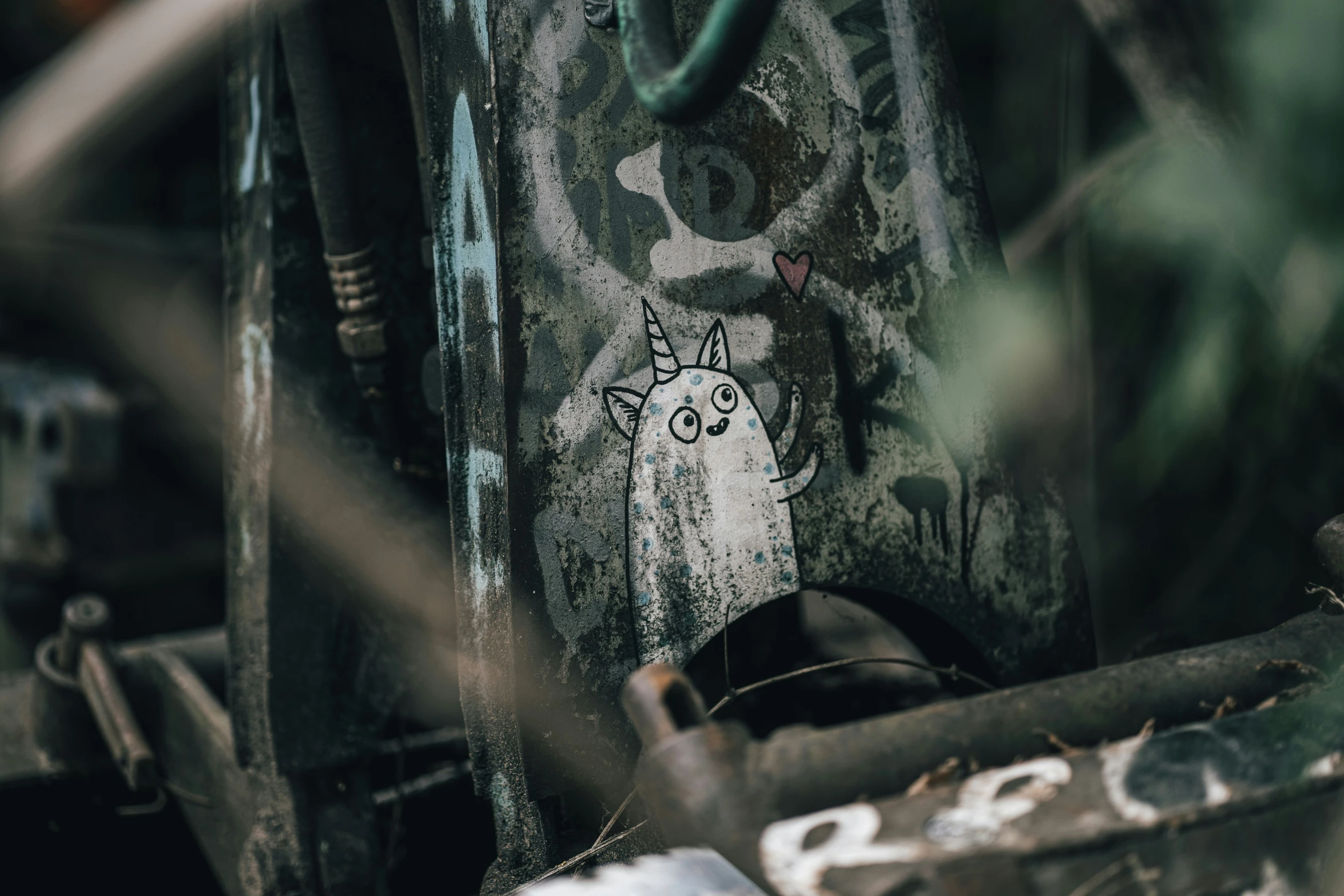 graffiti on a wooden door that is surrounded by junk