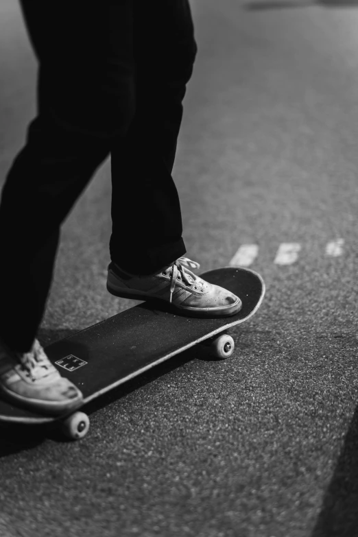 a person is standing on a skateboard in black and white