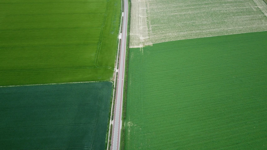 aerial view of a farm land with traffic and lines