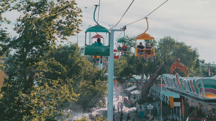 a number of rides and people riding in a roller coaster