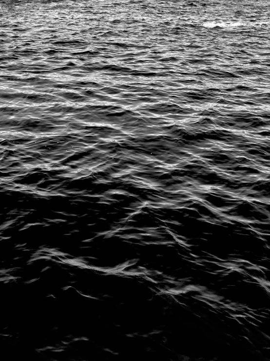 black and white pograph of a boat on the water