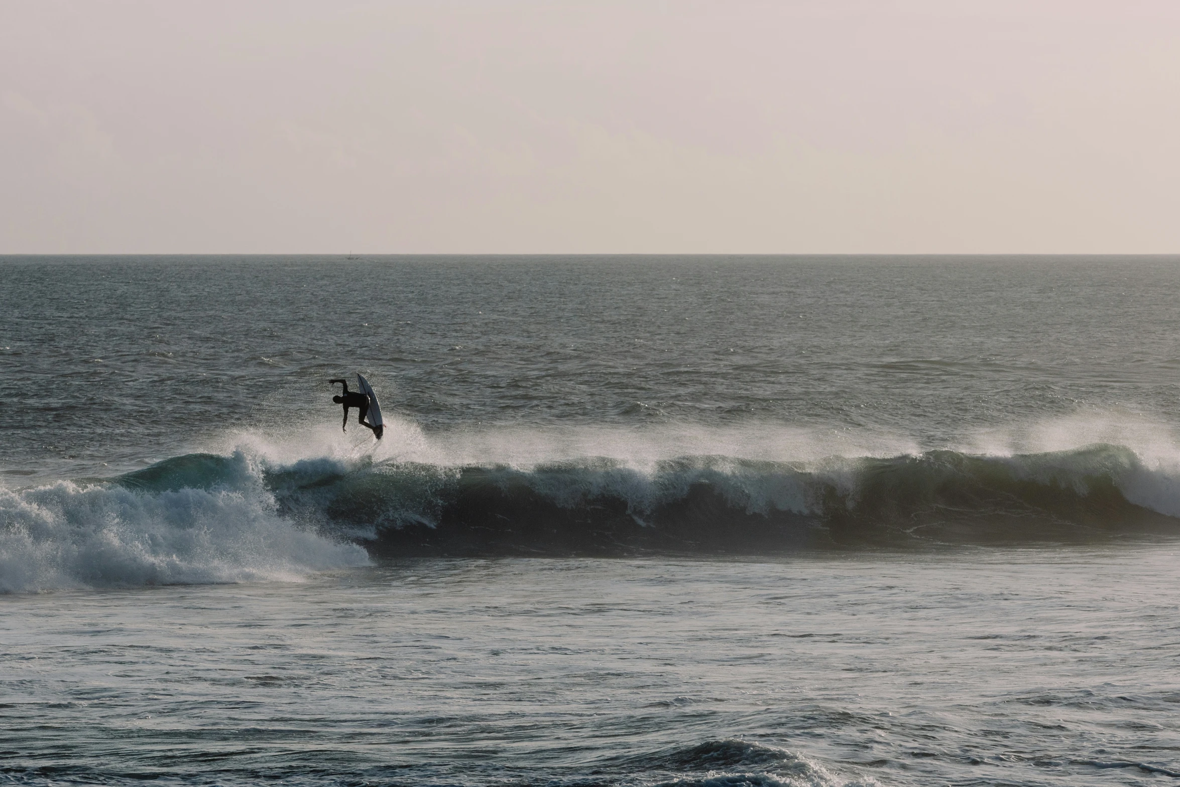 a person surfing a large wave in the ocean