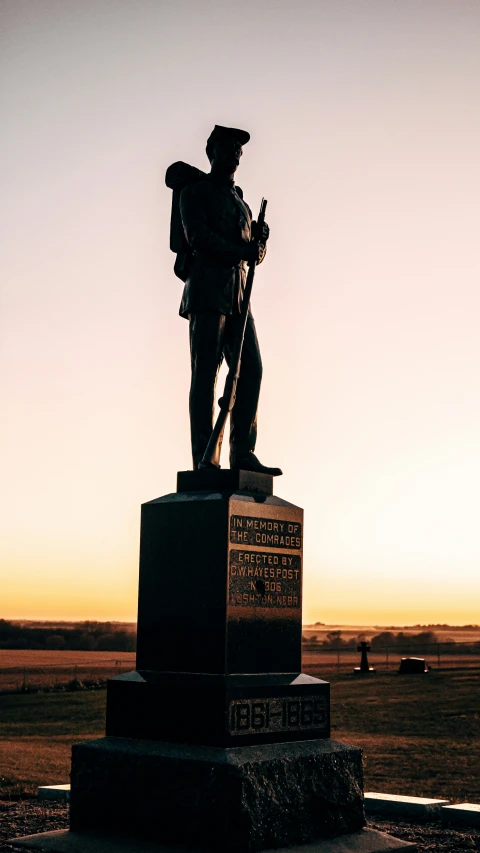 a statue is standing on the sidewalk with a backpack and rifle