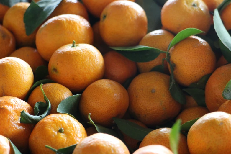 a pile of oranges sitting on top of each other