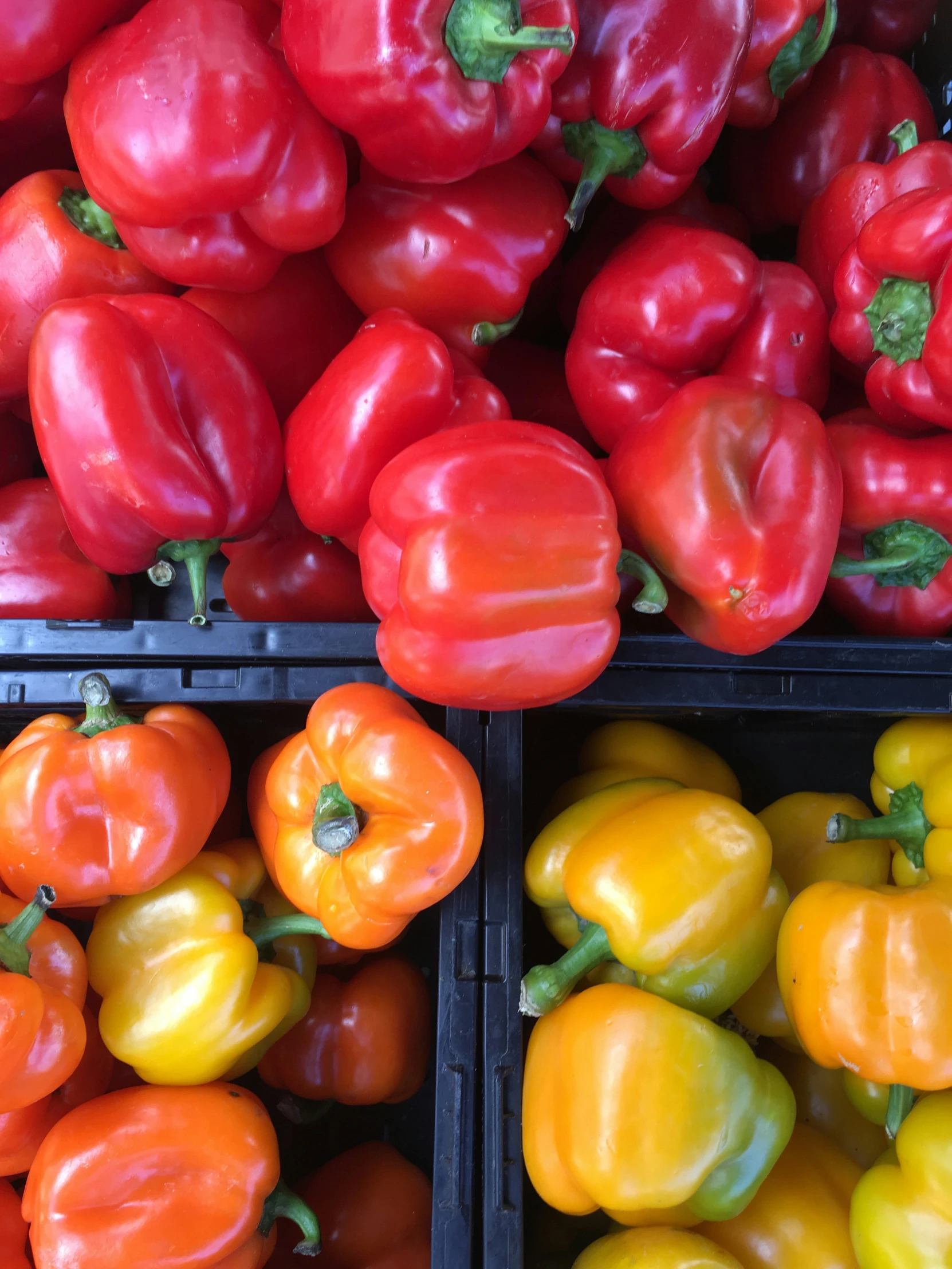 many red and yellow peppers stacked up together