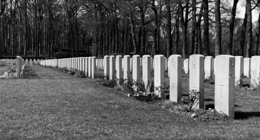 a line of graves are in the grass